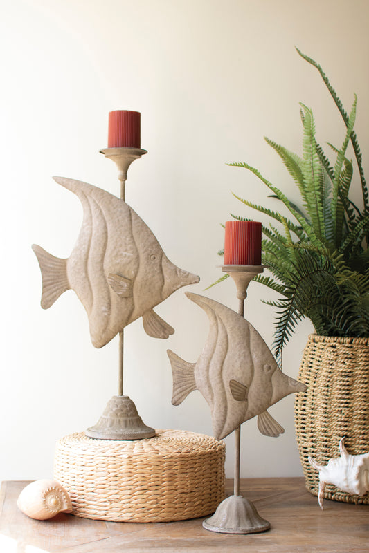 Two antique green fish with a distressed finish and intricate carvings, adding coastal charm to a shelf or tabletop.