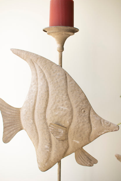 Two antique green fish with a distressed finish and intricate carvings, adding coastal charm to a shelf or tabletop.