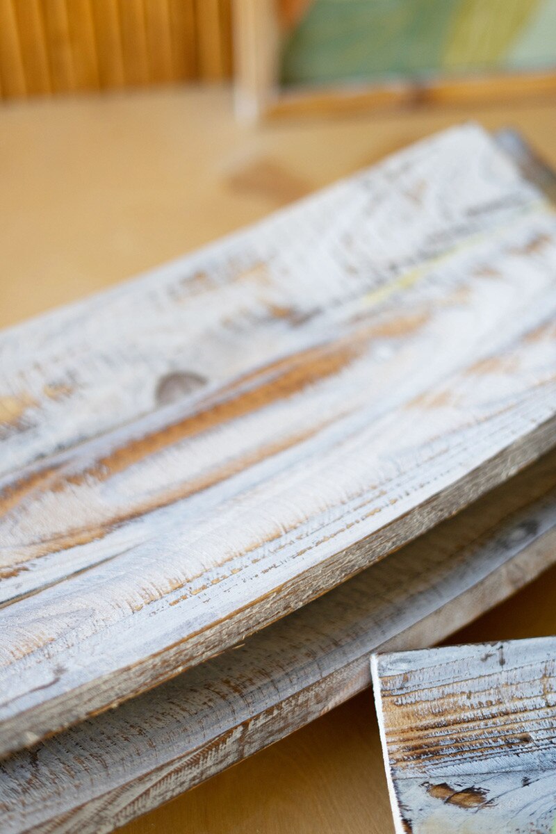 Set of three driftwood trays with a sun-bleached finish, perfect for adding coastal charm to any room; versatile and decorative.