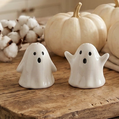 White ceramic ghost salt and pepper shakers with black eyes, a cute spooky Halloween kitchen accent