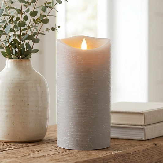 Candle and vase on a wooden surface with a blurred background