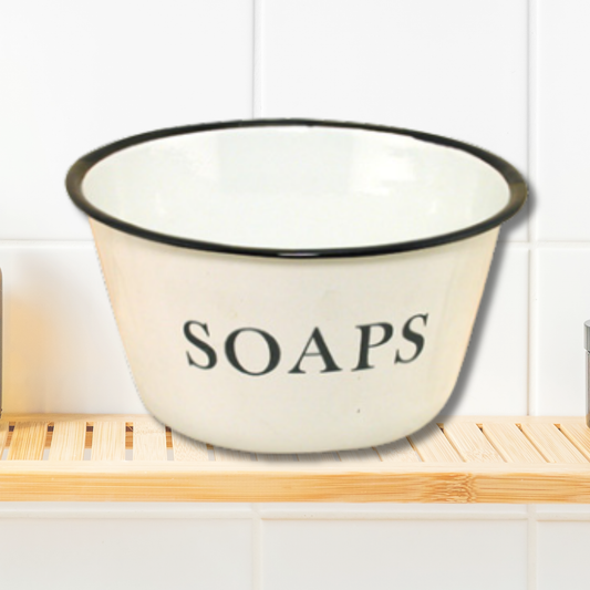 White bowl with black rim and 'SOAPS' text on a wooden shelf.
