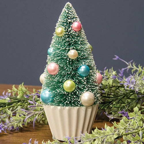 Teal bottle brush tree with faux snow, pastel pearl baubles in blue, pink, green, white on a pleated white base.