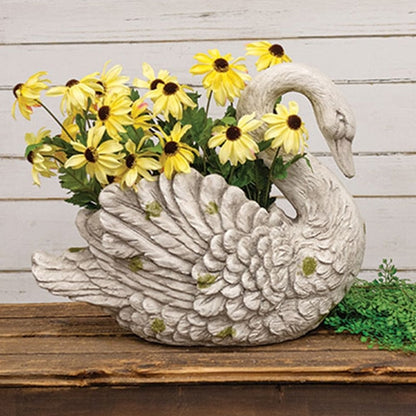Resin swan planter with detailed feathers, distressed white-gray finish, green moss accents, and a well for floral displays.