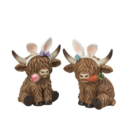 Two resin Highland cows with long brown hair, wearing bunny ear headbands; one holds a carrot, the other a pink rose.