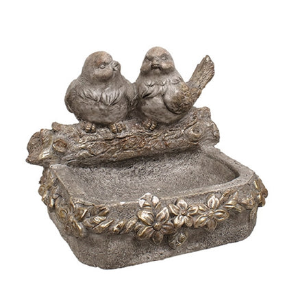 Distressed stone-look bird feeder with floral accents, featuring two carved birds on a log, in dimensional gray tones.