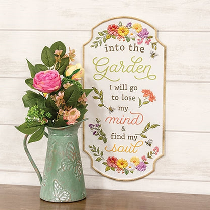 Into the Garden embossed floral metal sign with cream background, brown trim, colorful flowers, and scalloped corners.