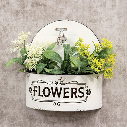 Distressed white farmhouse wall planter with arched top, rusty faux spicket, black rim, and vintage floral detailing.
