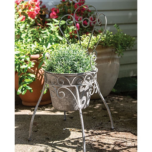 Antique-style metal garden chair planter with curled wire details and petal back for rustic farmhouse decor