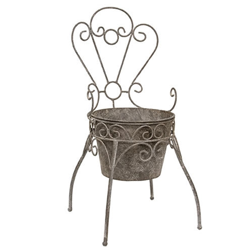 Antique-style metal garden chair planter with curled wire details and petal back for rustic farmhouse decor