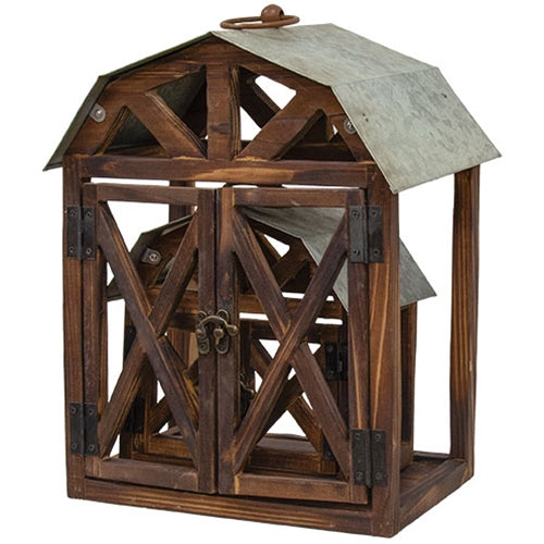 Rustic wood and metal barn-shaped lanterns with open sides, detailed roofs, and swinging doors, perfect for decor.