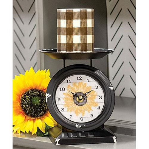 Farmhouse sunflower scale clock with black metal, distressed rust, white face, and vintage-style tabletop charm
