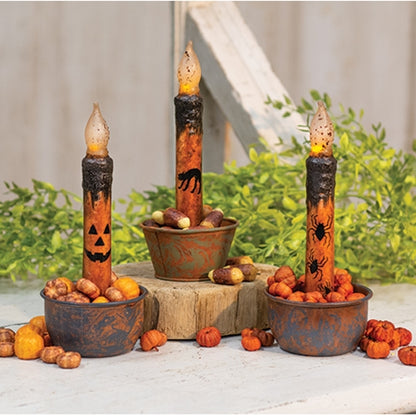 Halloween taper candle with grungy wax finish, warm flickering glow, and jack-o'-lantern, spider, or black cat designs
