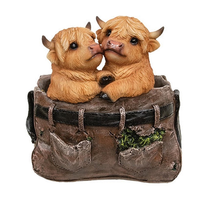 Resin planter shaped like brown pants with two cute Highland cows peeking out, featuring textured details and rustic charm.