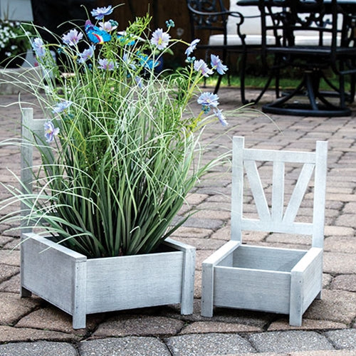 Wooden garden chair planter boxes with distressed whitewash finish, featuring open box base and detailed chairback design.