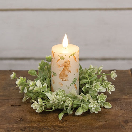 Carrot Top Pillar candle with faux flame, featuring bunnies, carrots, and eggs pattern, creating a cozy, whimsical atmosphere.