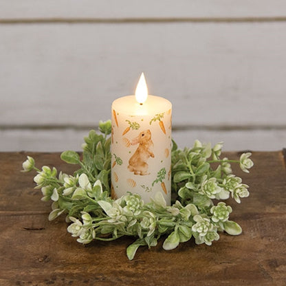 Carrot Top Pillar candle with faux flame, featuring bunnies, carrots, and eggs pattern, creating a cozy, whimsical atmosphere.