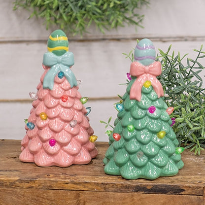 Two ceramic Easter egg LED table trees with textured leaves, pastel bulb lights, one in sage green and the other in medium pink.