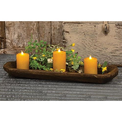 Oval-shaped carved wood bread bowl with a roughhewn texture and dark brown finish, adding rustic charm to home décor.