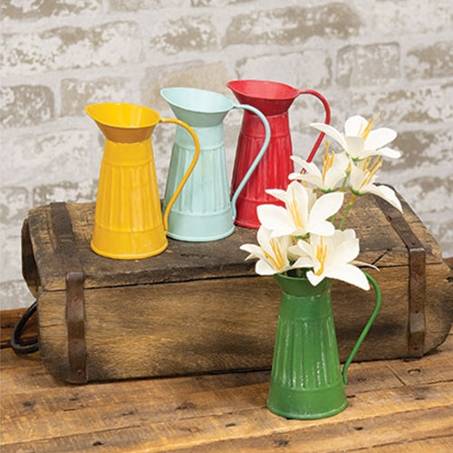 Mini distressed ribbed metal water pitcher with a flat base, long handle, and smooth spout in light blue, red, mustard, or green.