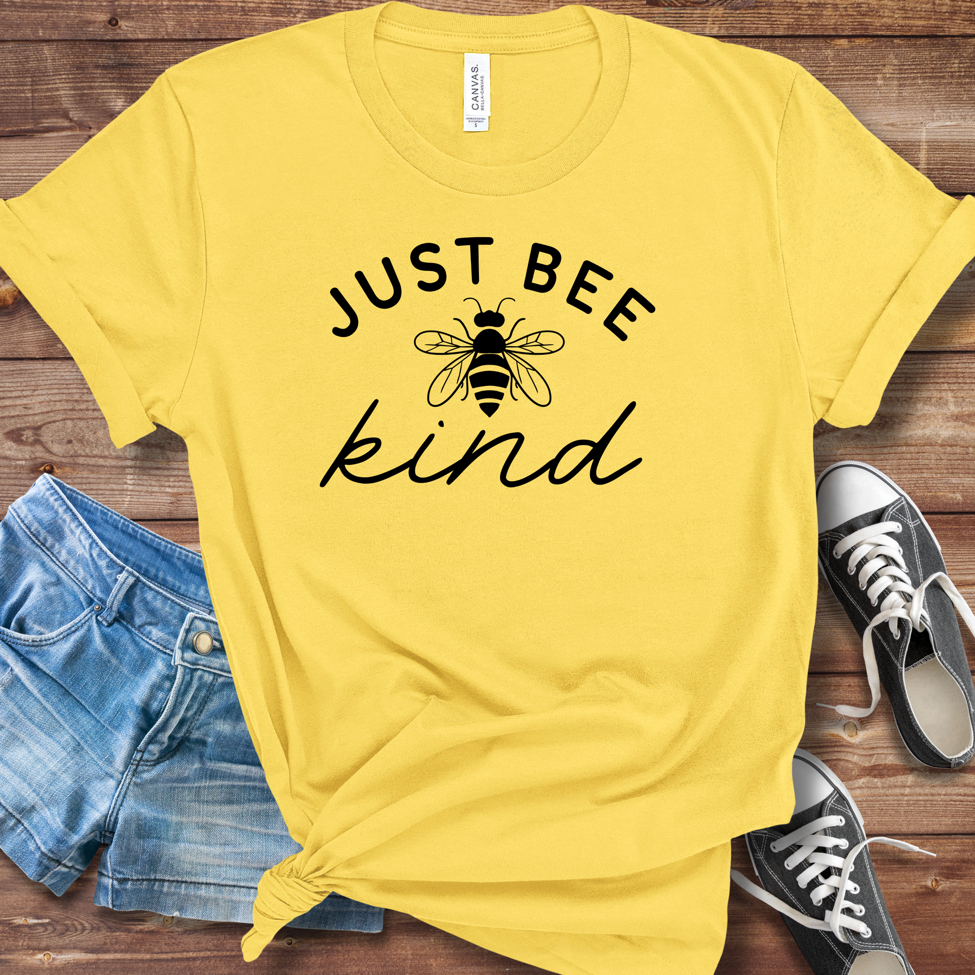 Rustic Just Bee Kind tee with sweet bee graphic and uplifting message in cozy farmhouse-inspired style.