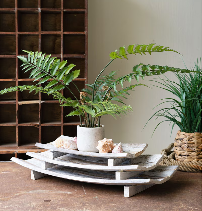 Set of three driftwood trays with a sun-bleached finish, perfect for adding coastal charm to any room; versatile and decorative.