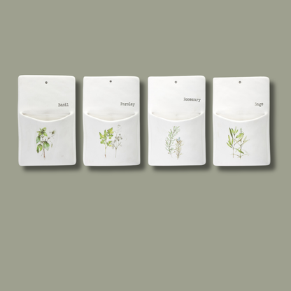 Four white wall-mounted herb pots with plant illustrations and labels on a gray background