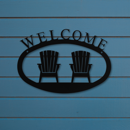 Metal 'Welcome' sign with two chairs on a blue wooden background