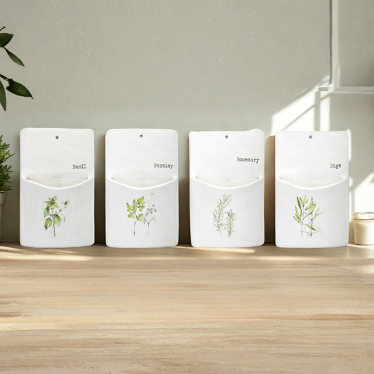 Four white containers with plant illustrations and labels on a wooden surface.