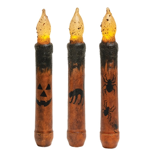 Halloween taper candle with grungy wax finish, warm flickering glow, and jack-o'-lantern, spider, or black cat designs