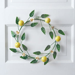 A vibrant lemon wreath with cheerful colors and charming flowers, crafted from durable metal, hanging on a door.
