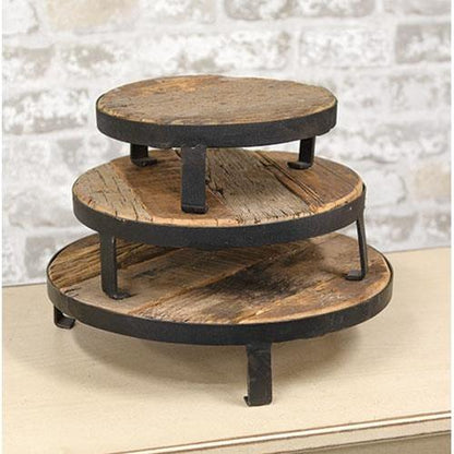 Set of three round risers made of weathered wood and metal, each with a different size, ideal for rustic home decor displays.